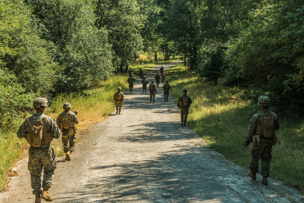 Marines dismounts maneuvering to an objective