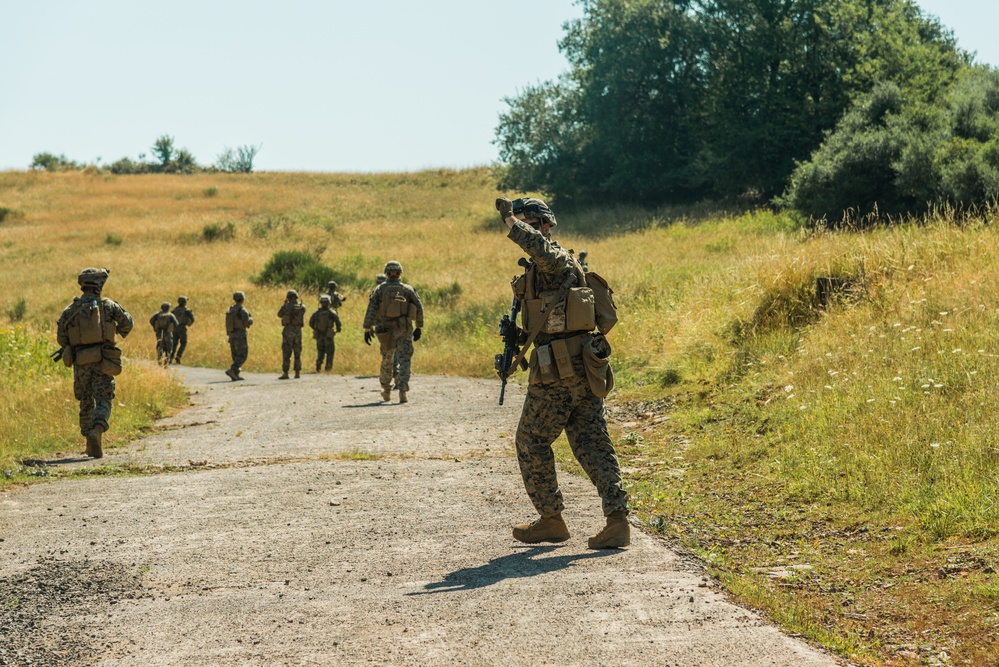 Marines dismounts maneuvering to an objective
