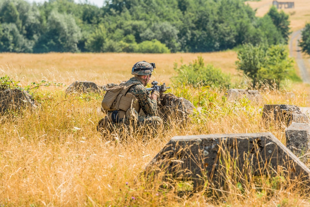 Marines dismounts maneuvering to an objective