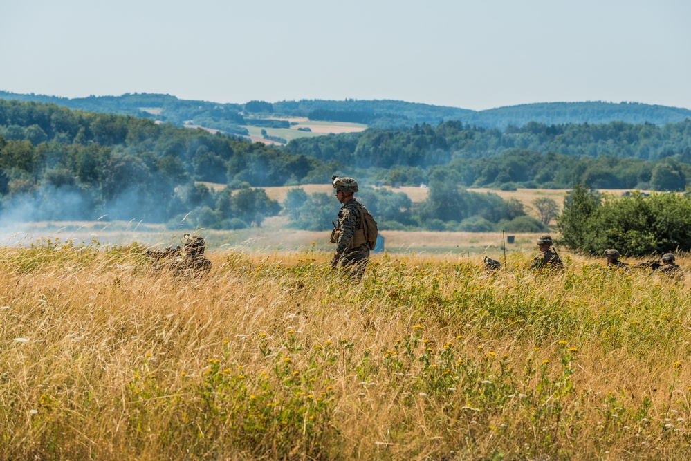 Marines dismounts maneuvering to an objective