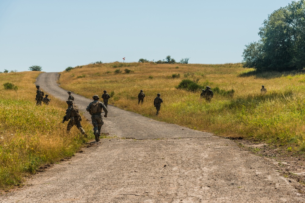 Marines dismounts maneuvering to an objective