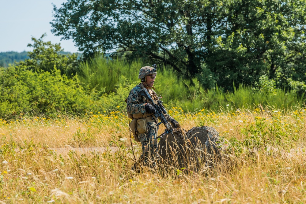 Marines dismounts maneuvering to an objective