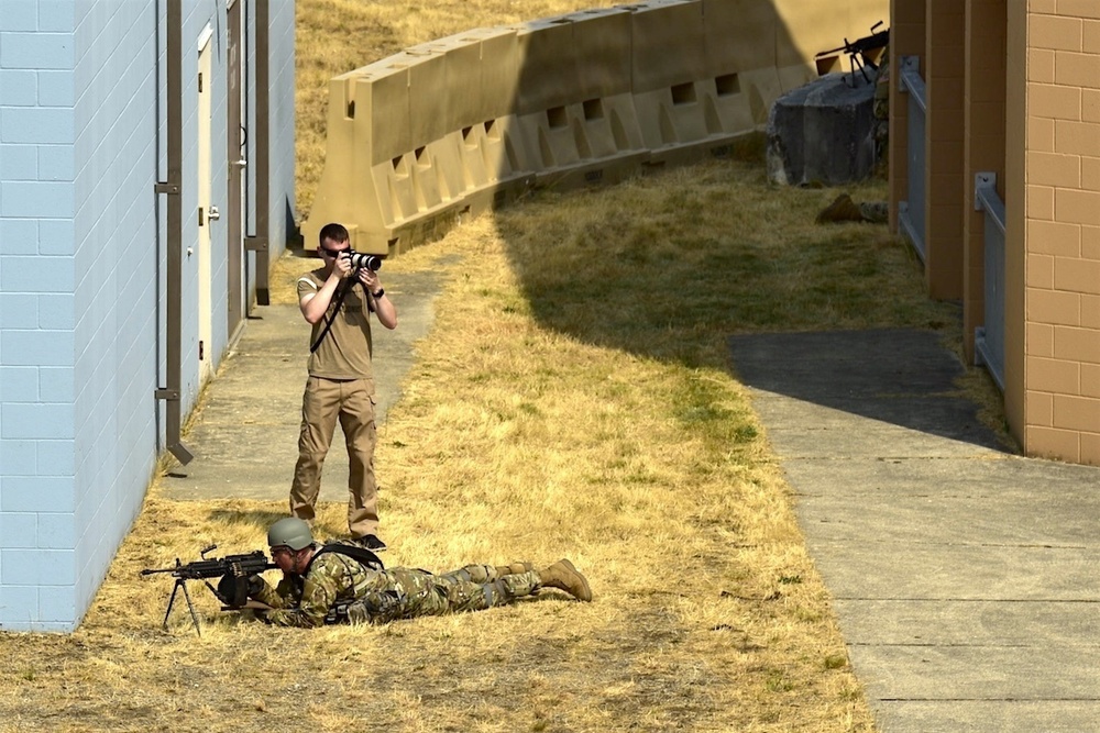 Spc. Bradey Petit takes OCS Phase III photos at Leschi Town