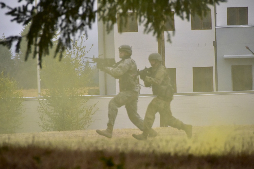 Officer candidates run through smoke