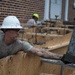 Staff Sgt. Ryan French pours a concrete stem wall