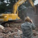 Airman 1st Class Mercedee Schwartz photographs building demolition