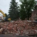 Airmen cleans up waste at condemned building demolition site