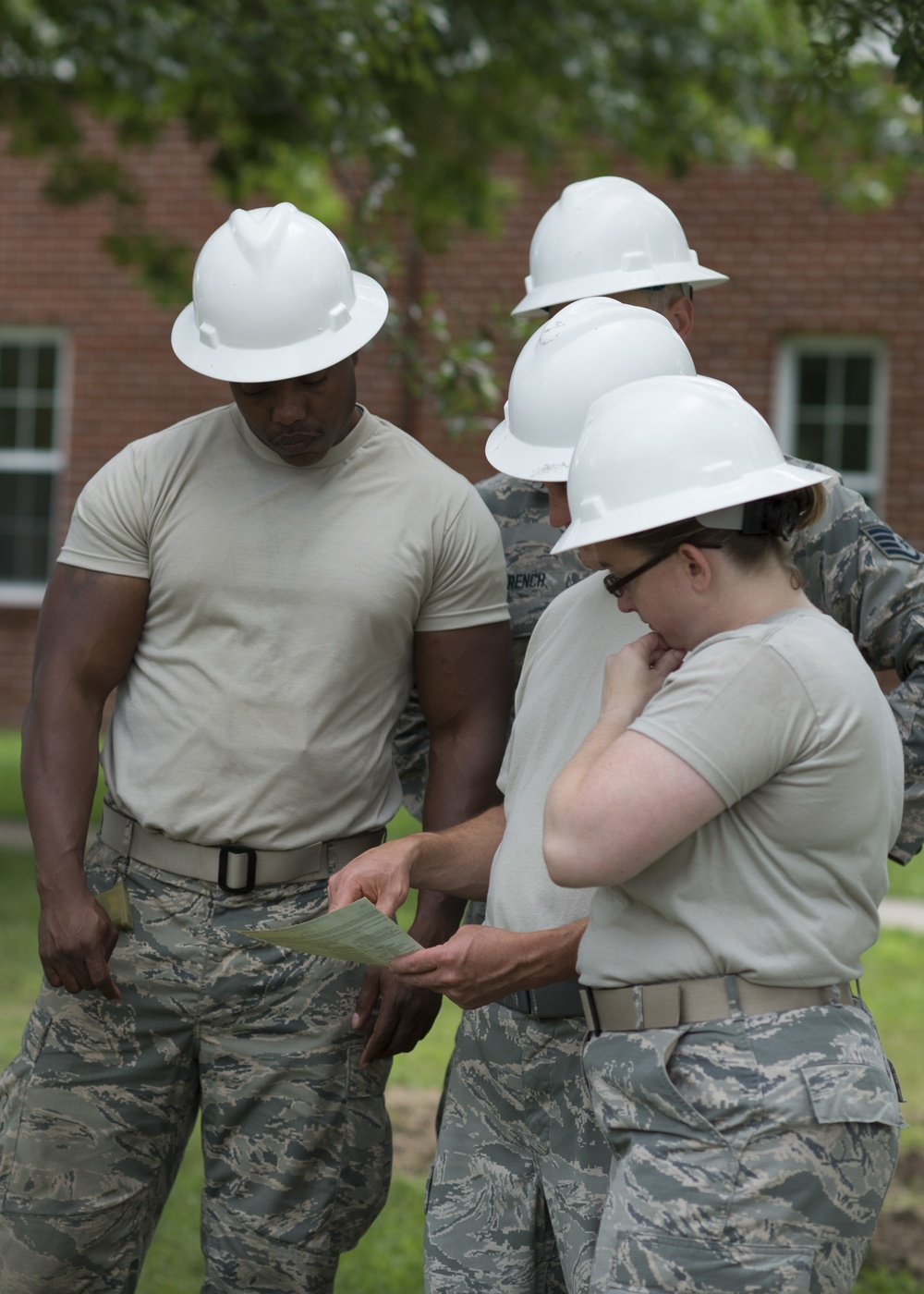 Airmen go over plans to build a parking lot during Innovative Readiness Training