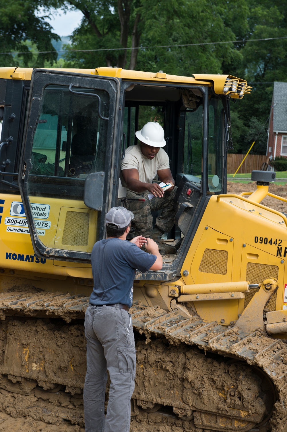 Airman signs for a delivery for a parking lot being built