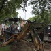 Airman operates excavator to dig for parking lot being built