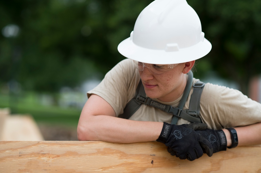 Airmen supervises the building of new wheelchair ramp