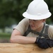 Airmen supervises the building of new wheelchair ramp