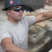 Airman assists with wheelchair ramp being built during Innovative Readiness Training