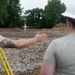 Airmen work on a new parking lot for school during Innovative Readiness Training