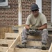 Airmen builds stairs and wheelchair ramp during Innovative Readiness Training