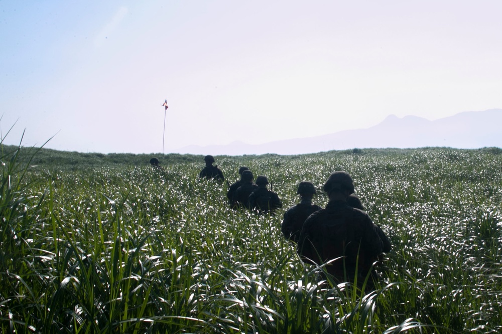 Marines with Company F fire and maneuver in Japan's hills