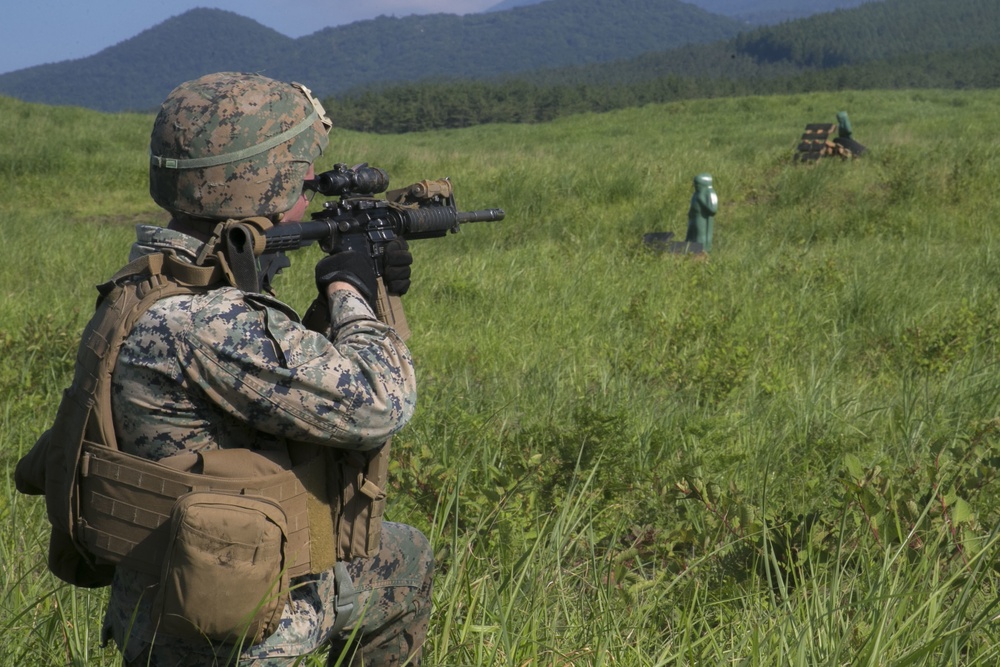 Marines with Company F fire and maneuver in Japan's hills