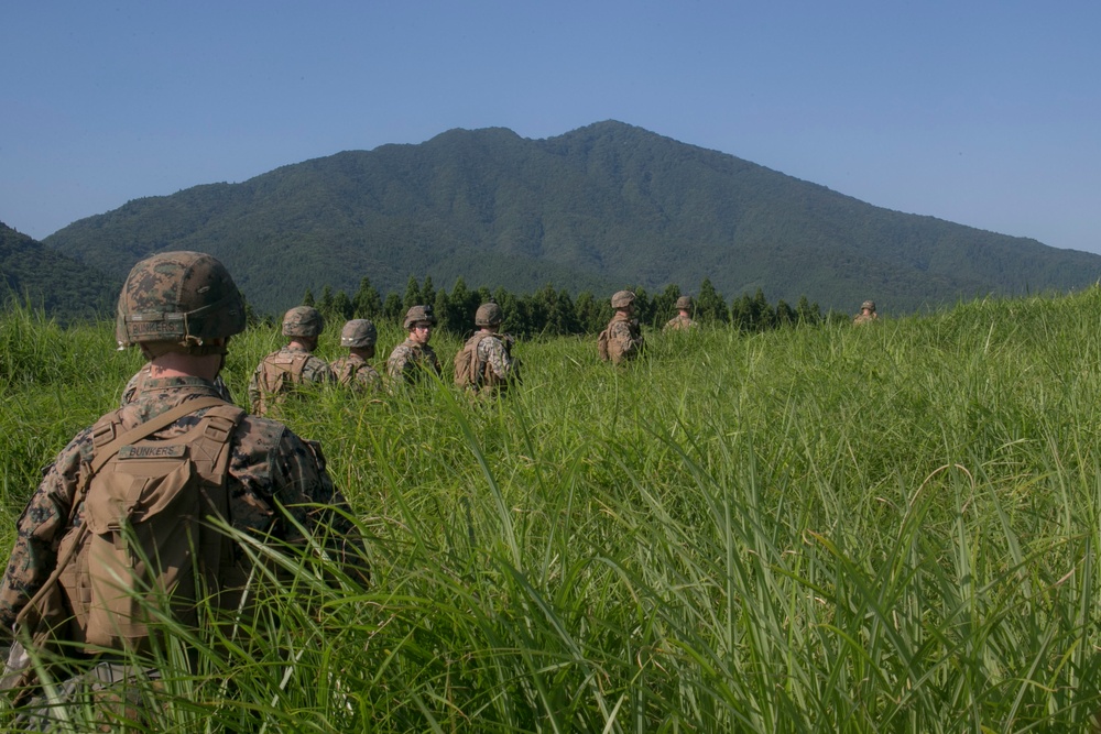 Marines with Company F fire and maneuver in Japan's hills