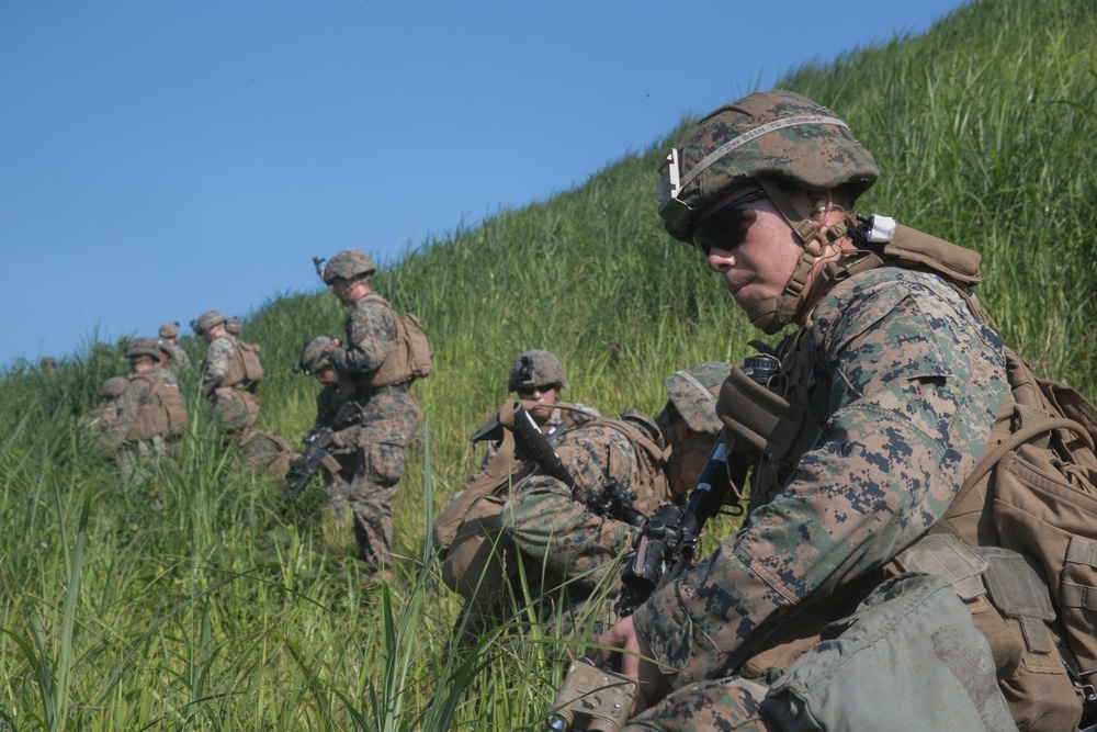 Marines with Company F fire and maneuver in Japan's hills