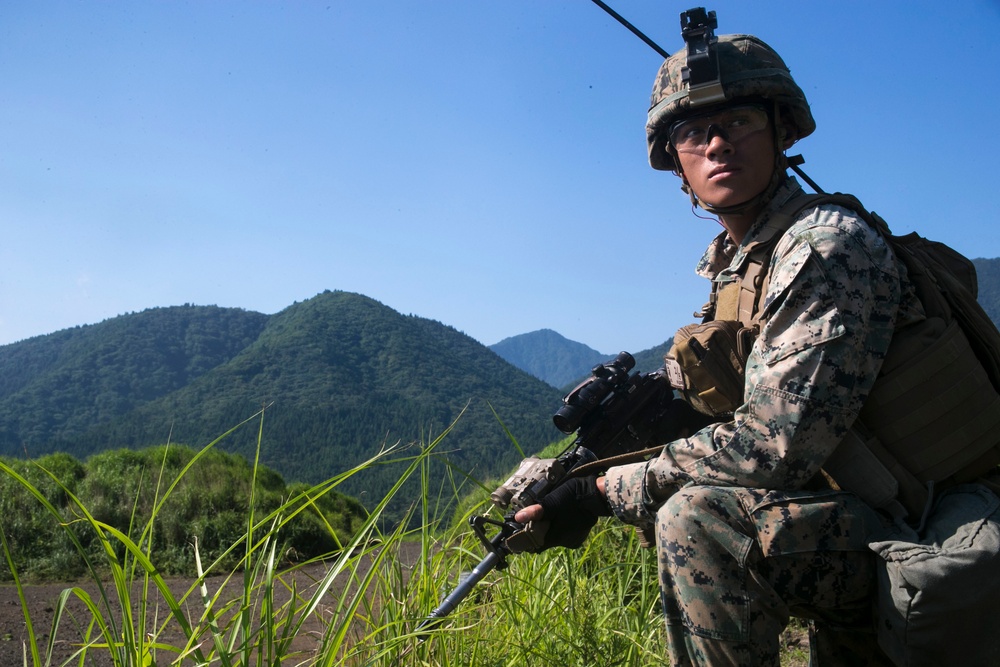 Marines with Company F fire and maneuver in Japan's hills