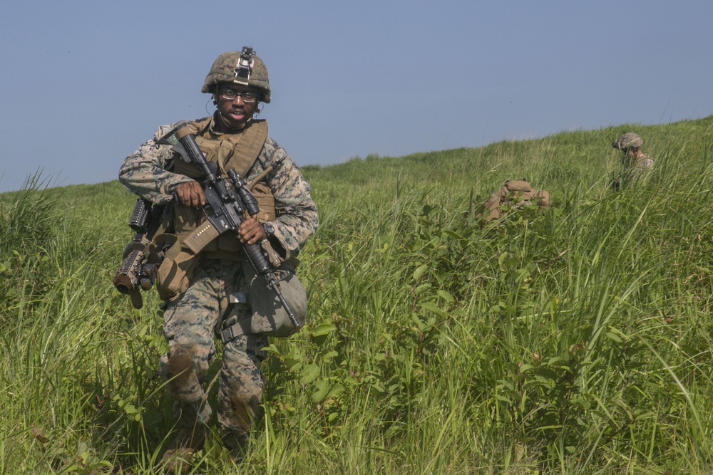 Marines with Company F fire and maneuver in Japan's hills