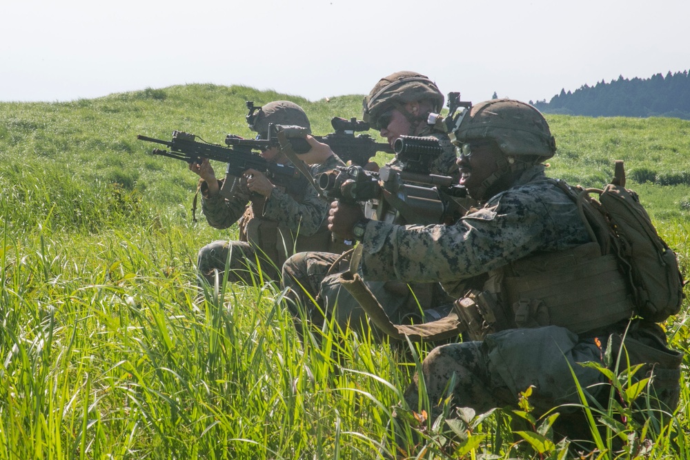 Marines with Company F fire and maneuver in Japan's hills