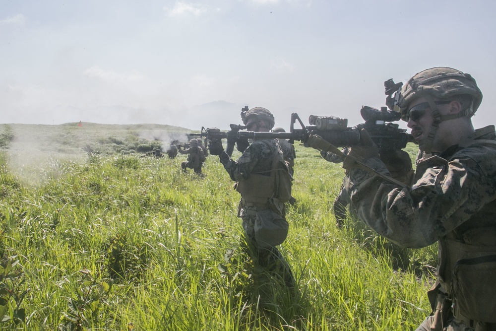 Marines with Company F fire and maneuver in Japan's hills