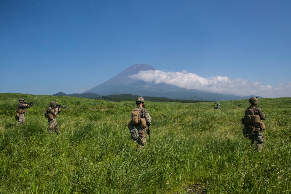 Marines with Company F fire and maneuver in Japan's hills