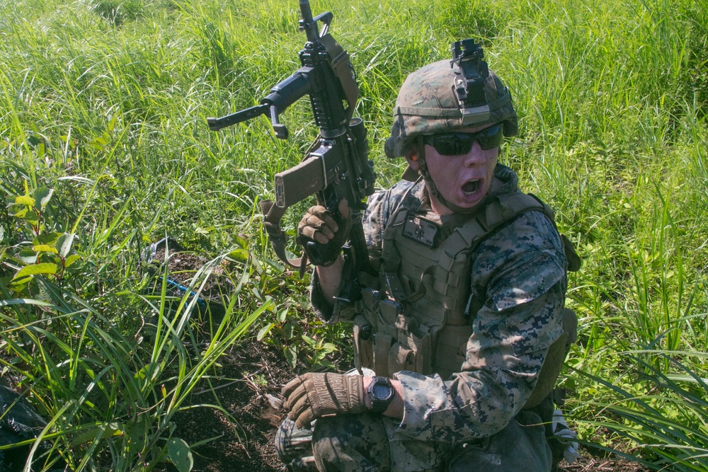 Marines with Company F fire and maneuver in Japan's hills