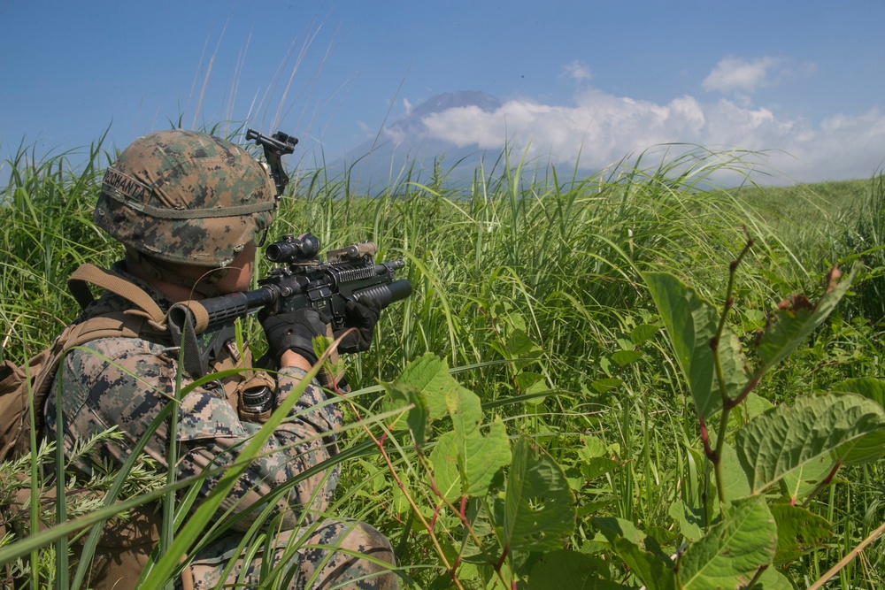 Marines with Company F fire and maneuver in Japan's hills