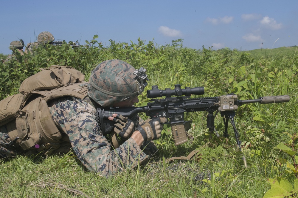 Marines with Company F fire and maneuver in Japan's hills