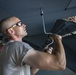 Crew chiefs perform wing maintenance on C-17