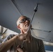 Crew chiefs perform wing maintenance on C-17