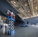 Crew chiefs perform wing maintenance on C-17