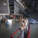 Crew chiefs perform wing maintenance on C-17