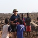 U.S. service members play soccer with local children