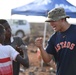 U.S. service members play soccer with local children