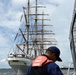 A Coast Guard Cutter Razorbill crewmember prepares to come along side the Coast Guard Cutter Barque Eagle