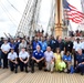 The Coast Guard Cutter Barque Eagle's crew gather with local community and industry members for a group photo