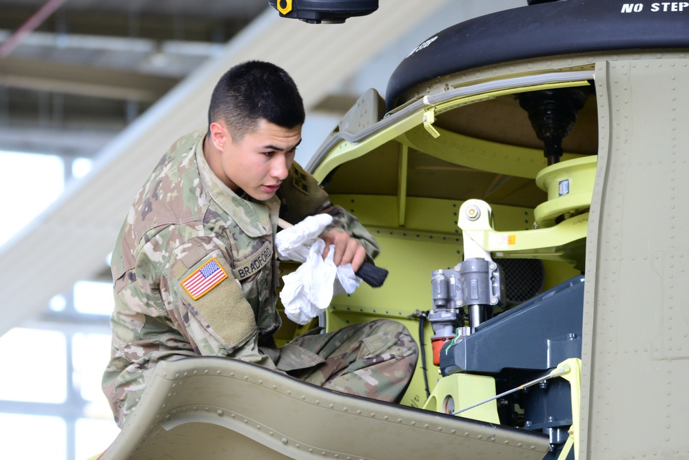 Soldier performing maintenance on a Chinook