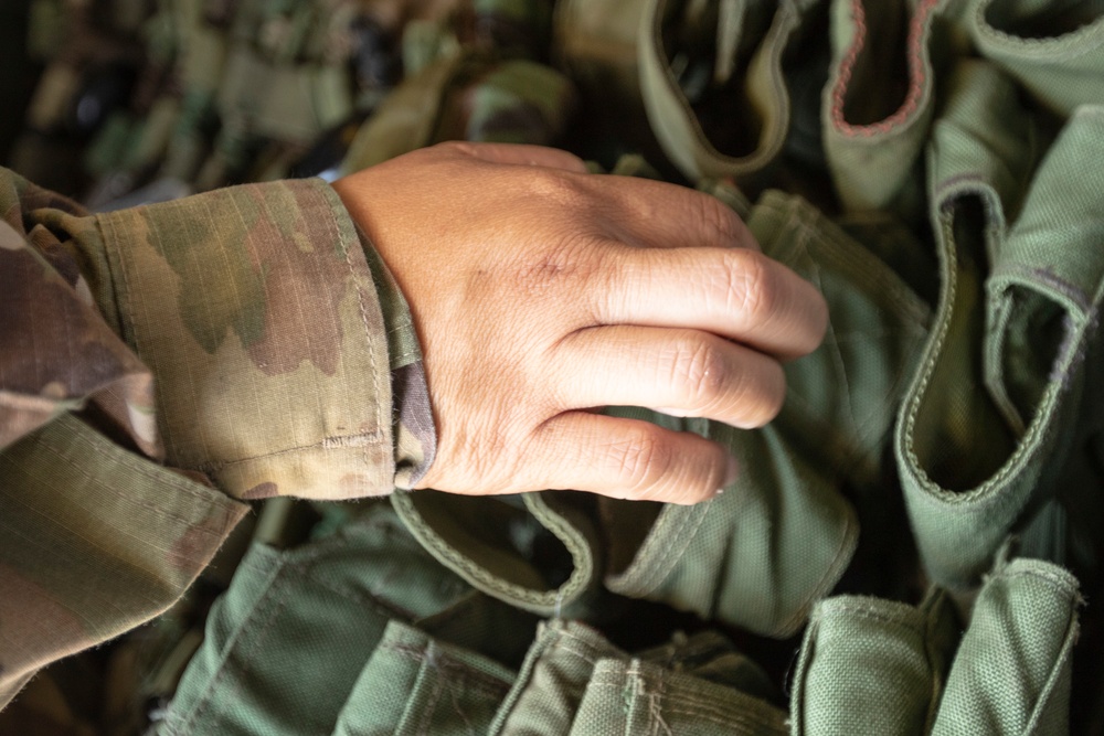 U.S. Army Reserve Soldiers check out MILES gear.