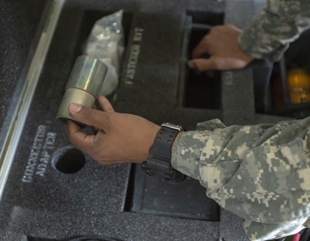 U.S. Army Reserve Soldiers check out MILES gear.