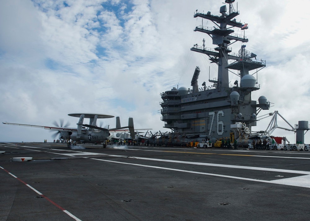An E-2D Hawkeye assigned to the “Tigertails” of Carrier Airborne Early Warning Squadron (VAW) 125 lands on the aircraft carrier USS Ronald Reagan (CVN 76) during flight operations.