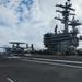An E-2D Hawkeye assigned to the “Tigertails” of Carrier Airborne Early Warning Squadron (VAW) 125 lands on the aircraft carrier USS Ronald Reagan (CVN 76) during flight operations.