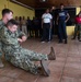 Hospital Corpsman 3rd Class Austin Jensen, from Seaboard, N.C., performs a one-person drag as part of a subject matter expert exchange with Trinidad and Tobago (TTO) military professionals