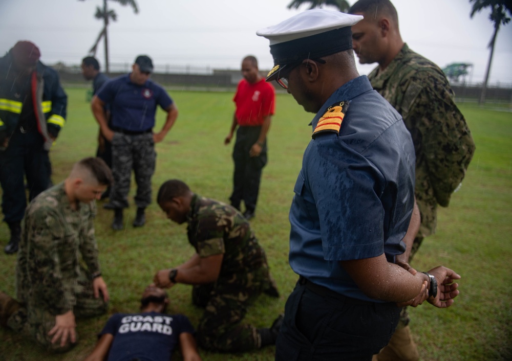 Cmdr. Israel Dowlat, the force surgeon of Trinidad and Tobago (TTO), observes U.S. Navy Sailors and TTO military professionals participating in a subject matter expert exchange