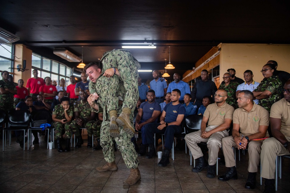 Hospital Corpsman 3rd Class Christian Winey, from Ludington, M.I., performs a fireman carry as part of a subject matter expert exchange with Trinidad and Tobago (TTO) military professionals