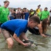 Brig. Gen. Wayne Monteith release sea turtle