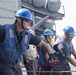 USS Antietam (CG 54) Sailor heaves a line during an underway replenishment with USNS Tippecanoe (T-AO-199)