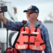 A Panama Canal Authority crewmember takes a selfie in front of the Coast Guard Cutter Fir